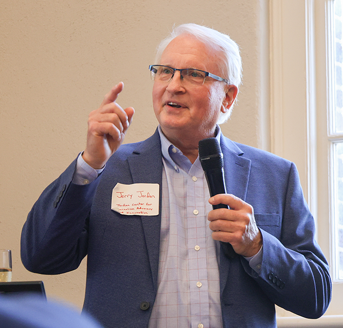 Jerry Jordan speaks into a microphone.