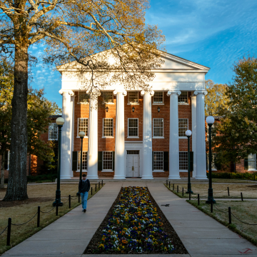 View of building with student walking in front