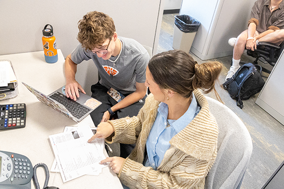 An advisor discusses classes with a student