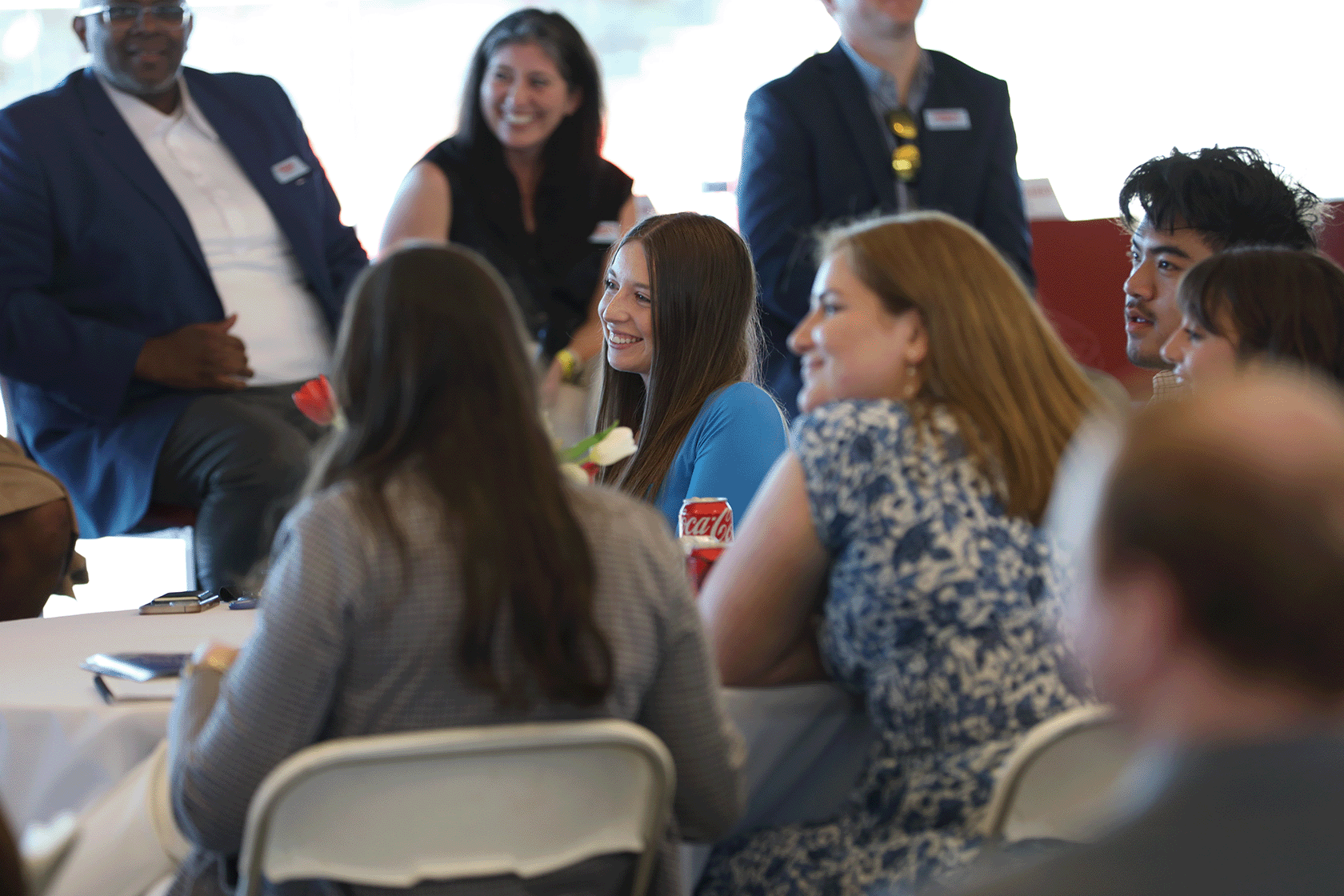 A student laughs while listening to a guest speaker.