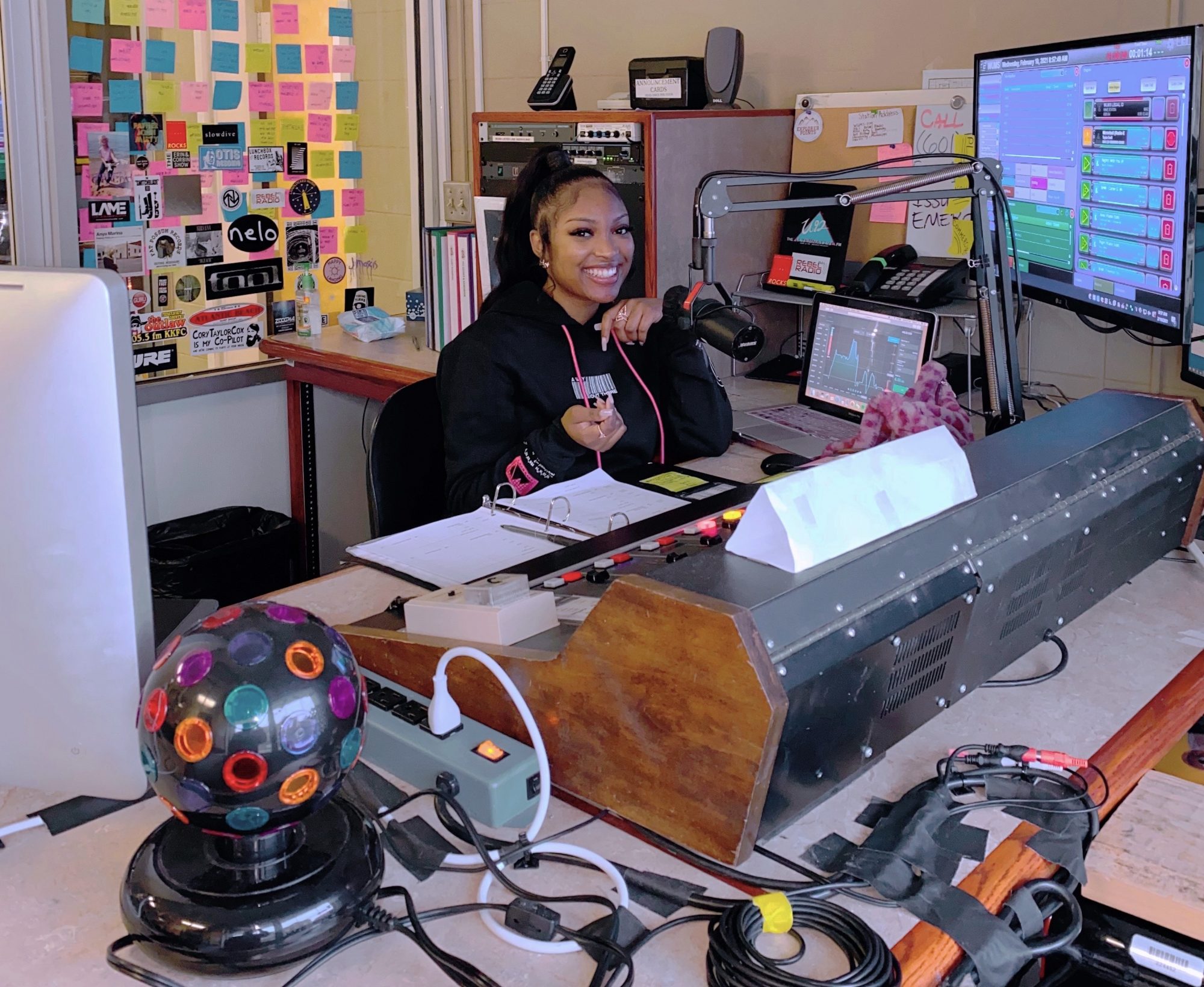 A student sits in a radio booth.