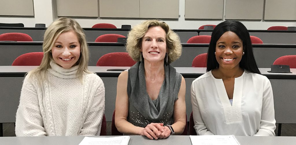 Senior Lecturer Robin Street discusses a class project with two students in her PR Case Studies class. From left, are IMC major Jessica Lanter, Street and IMC major Naiomei Young. Photo by Maddie Bridges.