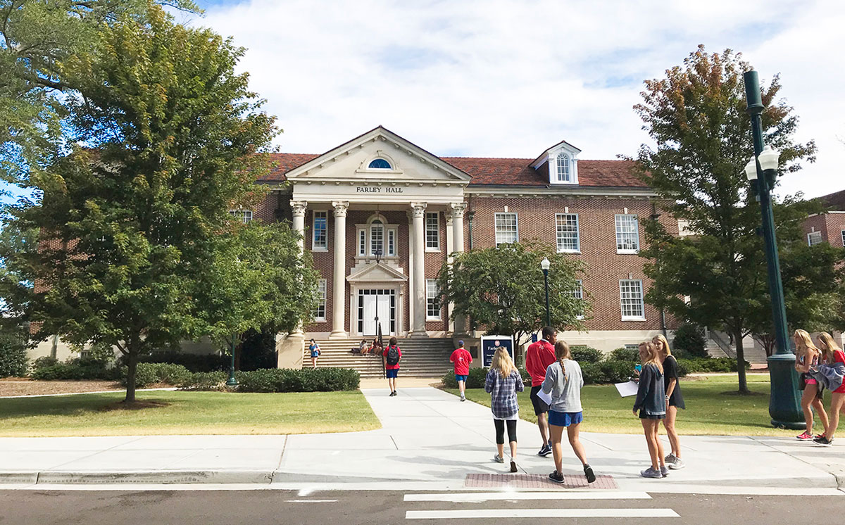 An outside shot of Farley Hall with students entering the building.