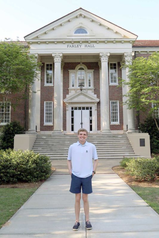 Jackson Sepko stands in the Grove in front of Farley Hall. 