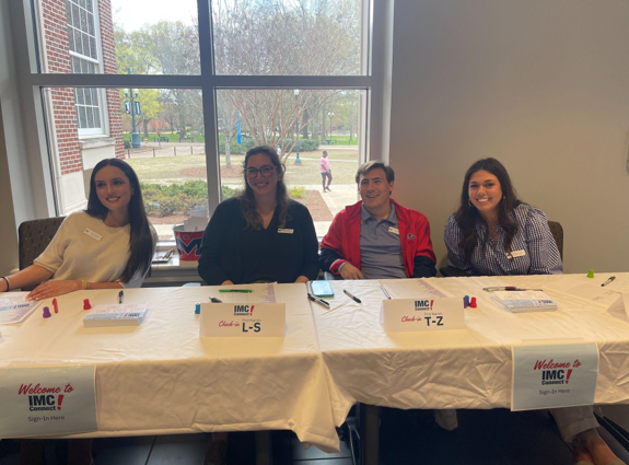 IMC 580 students Jaclyn Mansour, Nicole Wishard, Haughton Mann, and Margaret Savoie helping check in students before the panel began. 