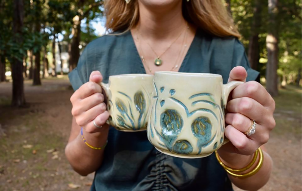 IMC graduate Shelby Toole with her pottery.